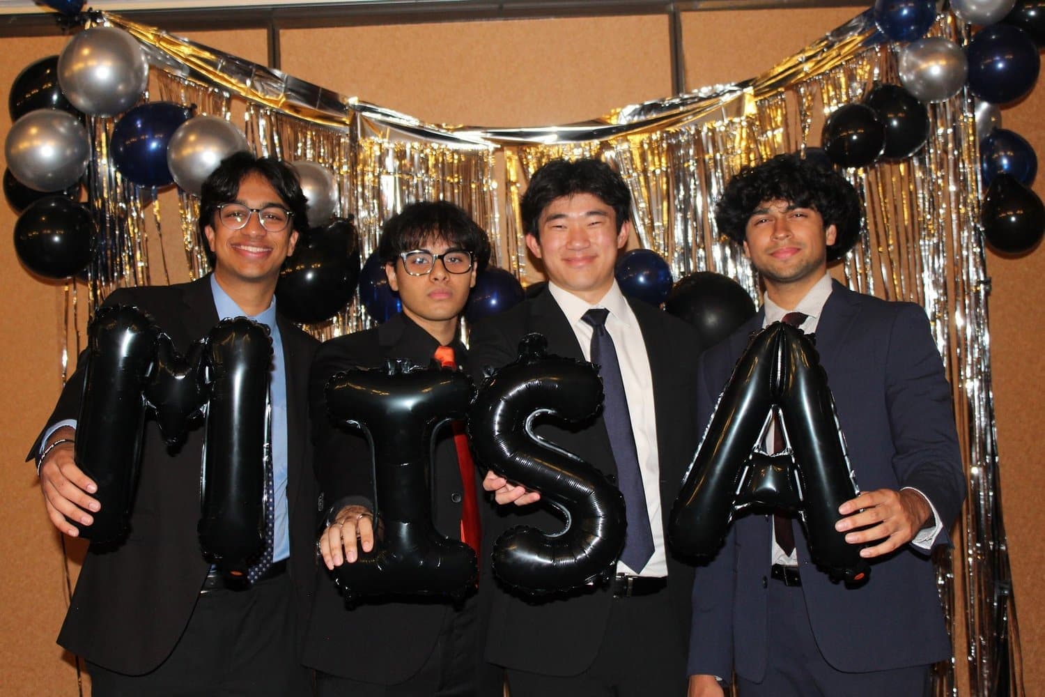 MISA members holding balloon letters spelling MISA at a chapter celebration