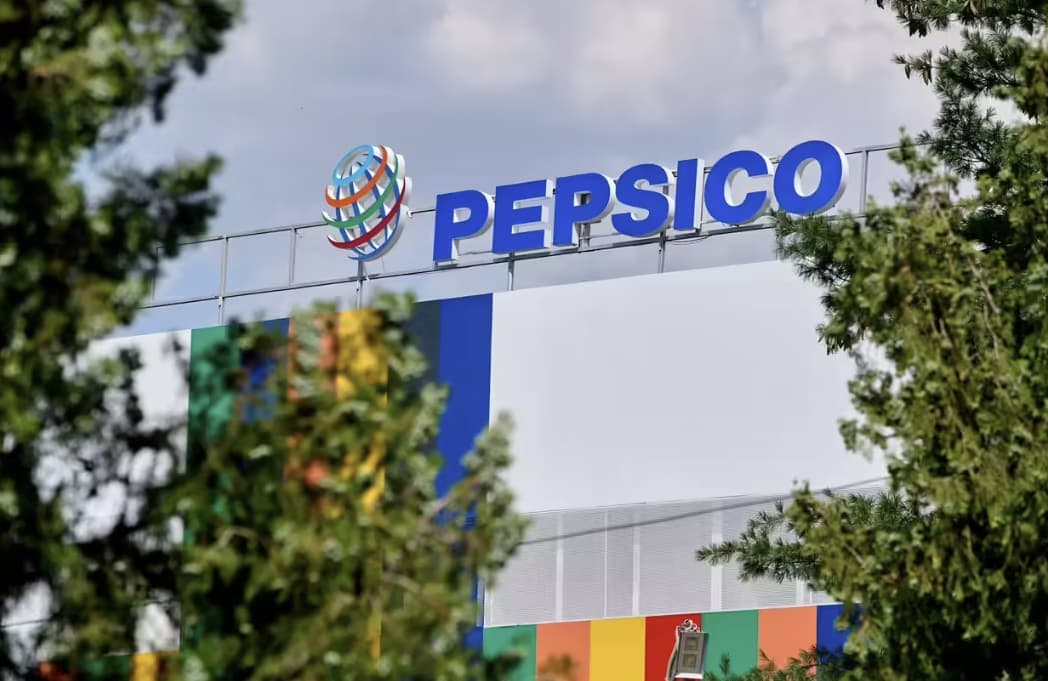 The PepsiCo sign on the roof of the company's corporate campus, seen through trees